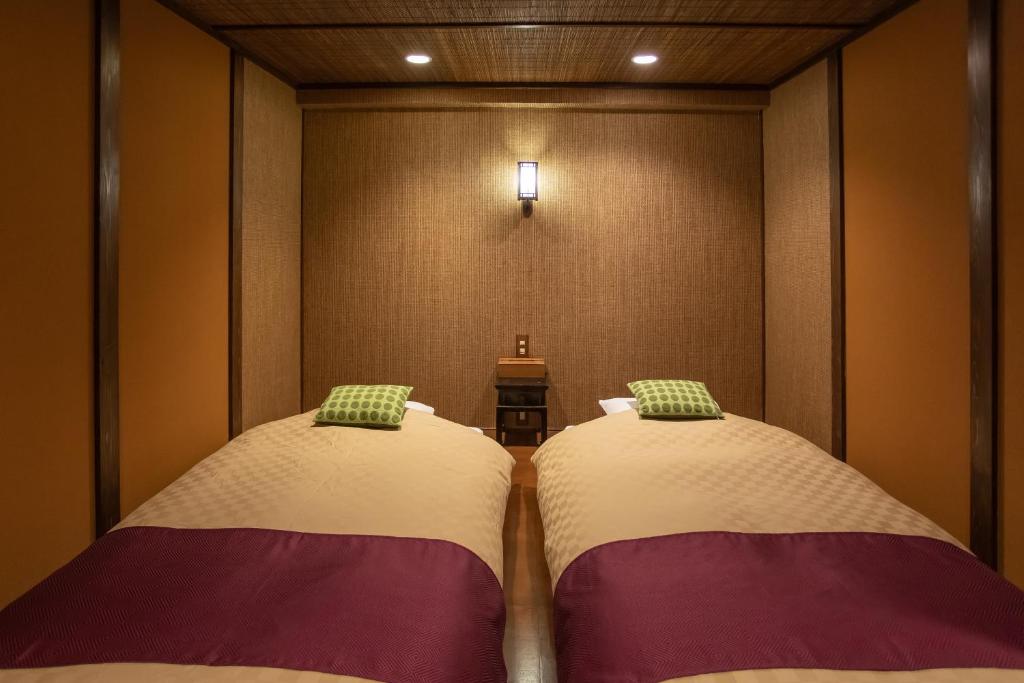 Postel nebo postele na pokoji v ubytování Izu atagawa Yubana mankai -Adult Only-