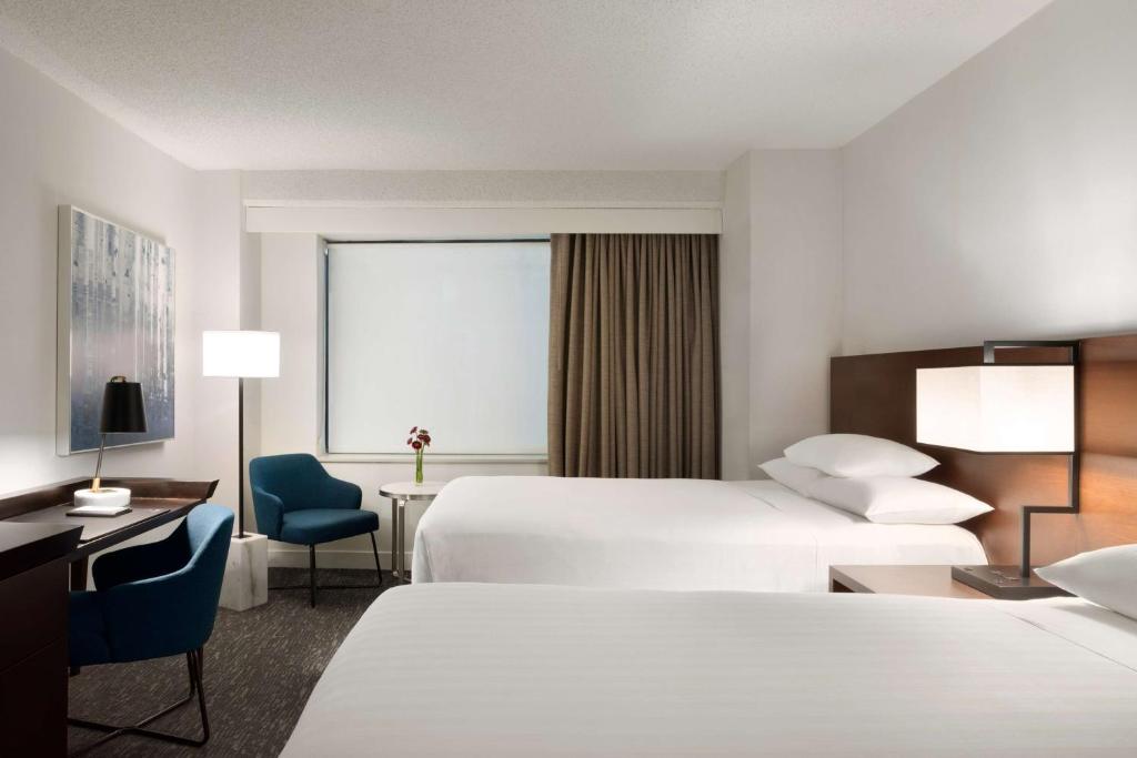 um quarto de hotel com duas camas e uma secretária em Hyatt Regency Schaumburg Chicago em Schaumburg
