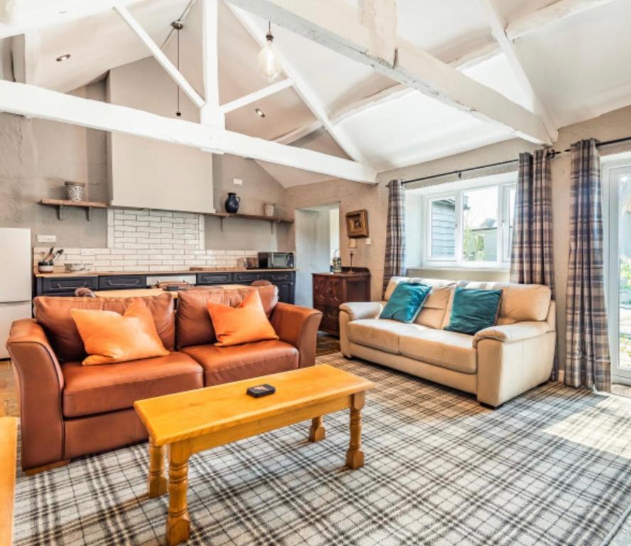 a living room with two couches and a coffee table at Octon Cottages Luxury 1 and 2 Bedroom cottages 1 mile from Taunton centre in Taunton