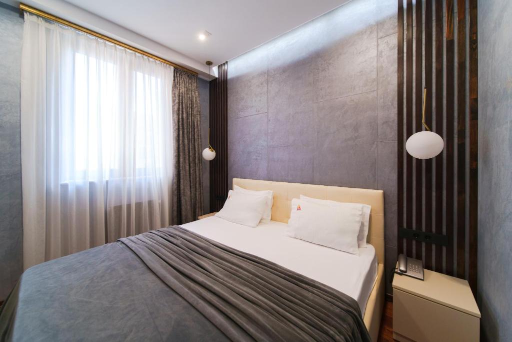 Postel nebo postele na pokoji v ubytování Arch Apart Hotel