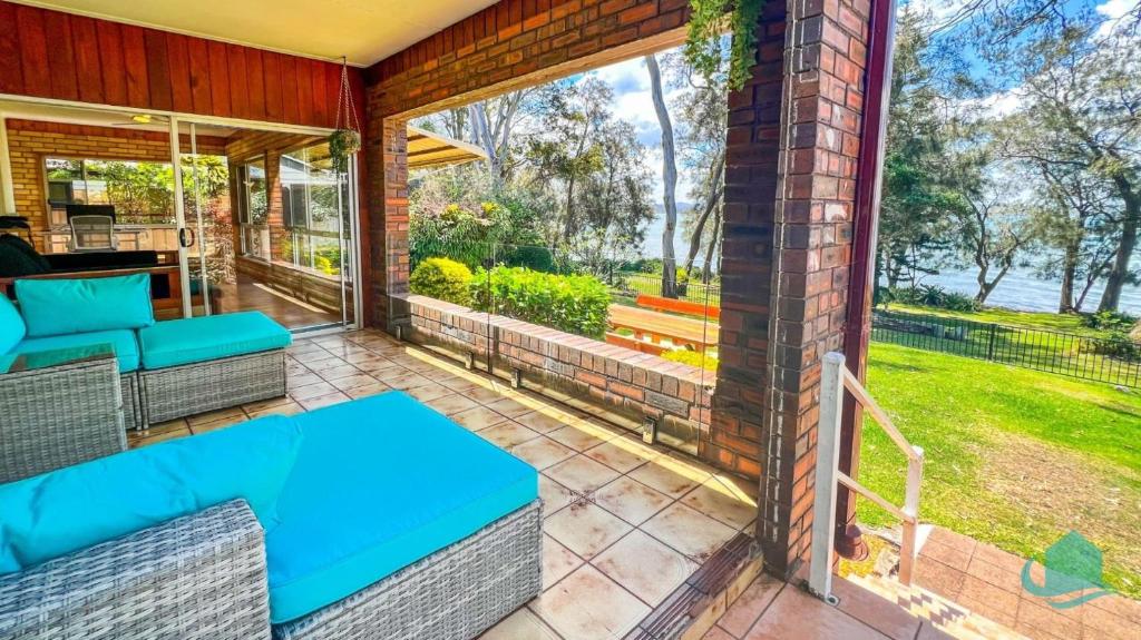 an outdoor patio with a table and chairs at Serendipity in Eraring