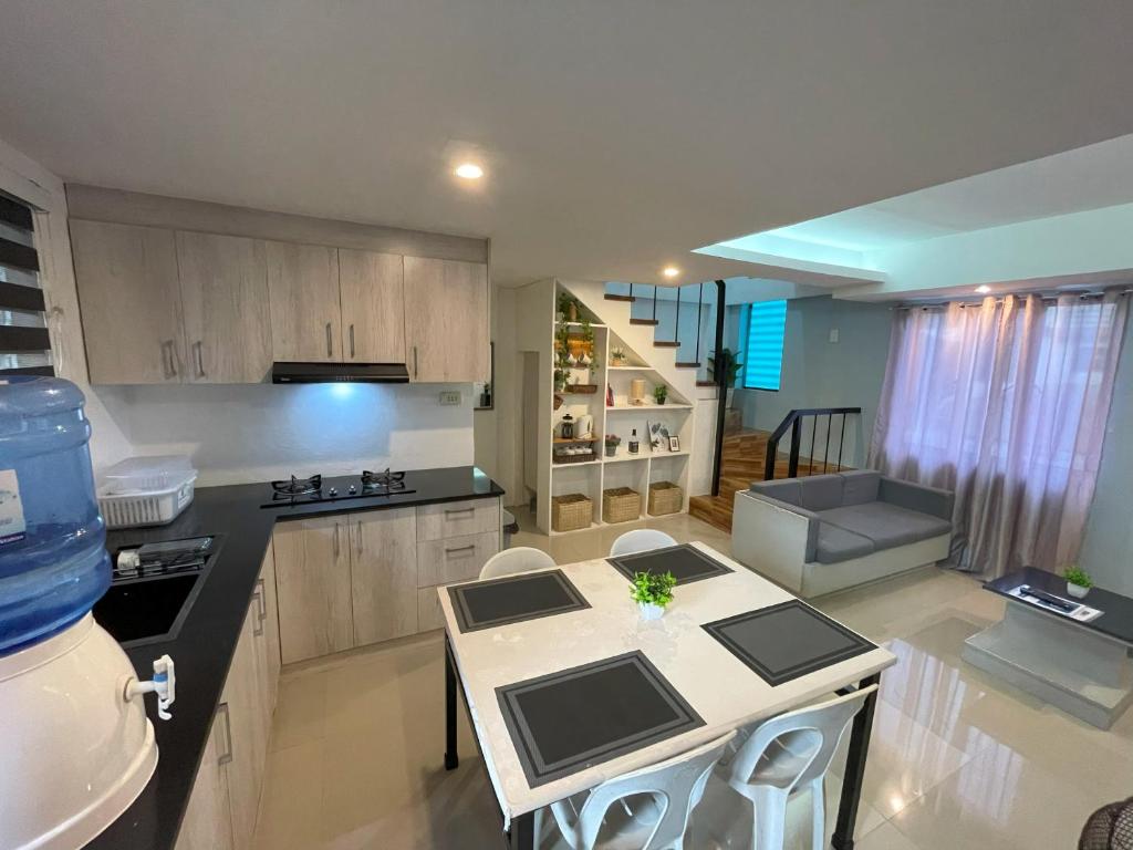 a kitchen with a table and a kitchen with a dining room at House In Subdivision- Lapu-Lapu City Near Airport and CCLEX in Lapu Lapu City