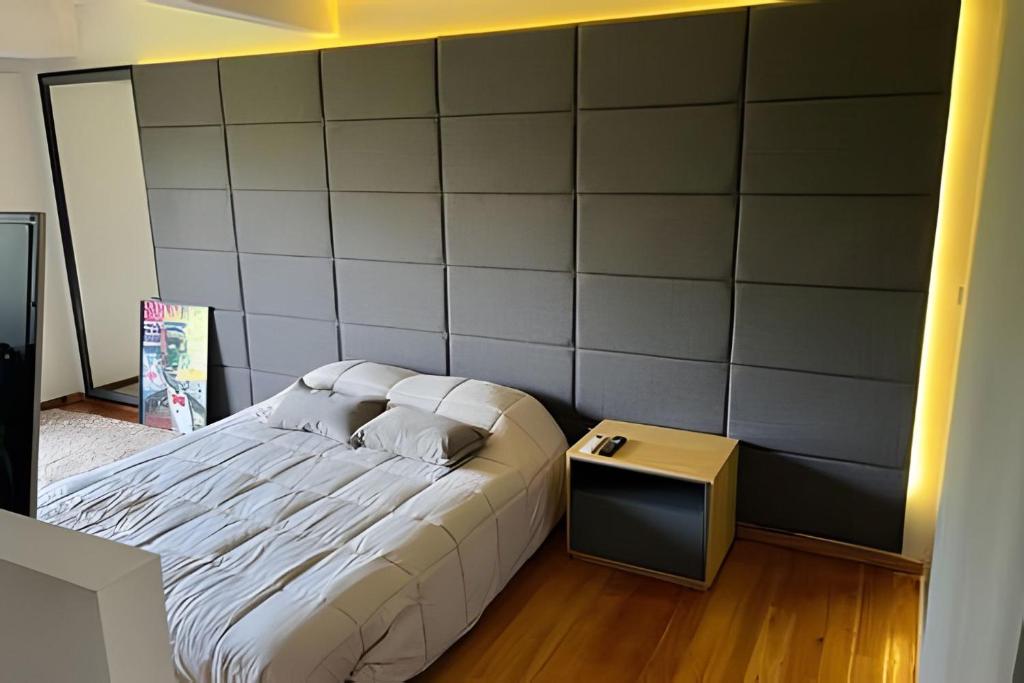a bedroom with a bed with a large wall at Luxury Apartment Palermo Hollywood in Buenos Aires