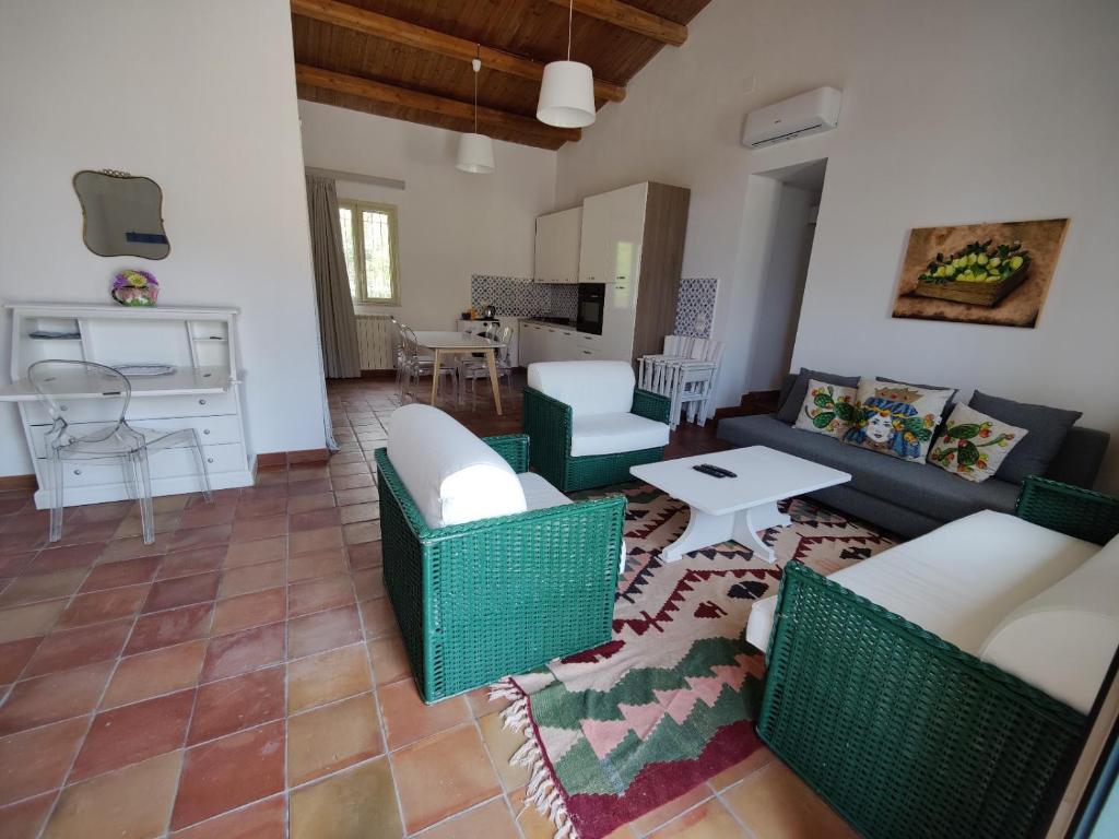 a living room with a couch and chairs and a table at Casa Titì in Cefalù