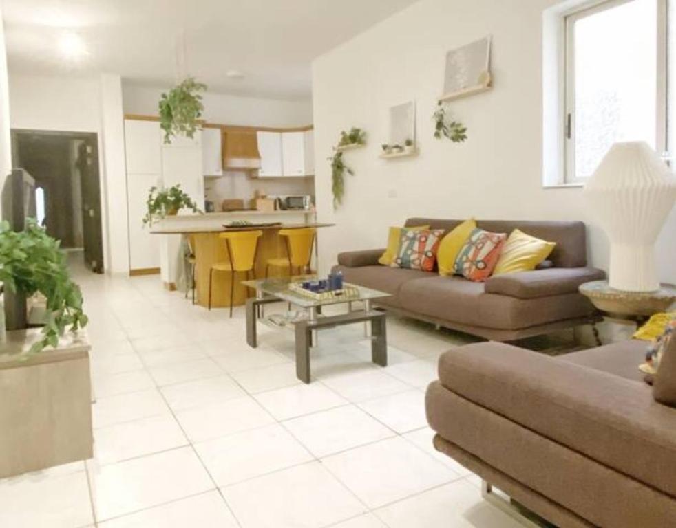 a living room with a couch and a table at Top location Sliema stylish rooms in Sliema