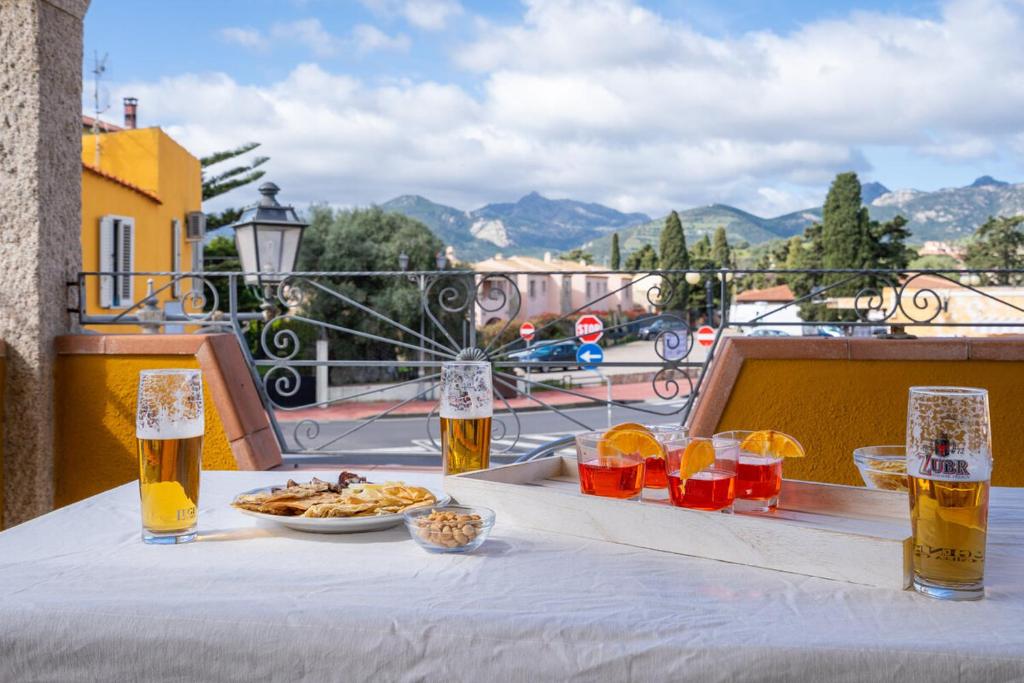 a table with a plate of food and two glasses of beer at Casa Rockefeller in San Teodoro