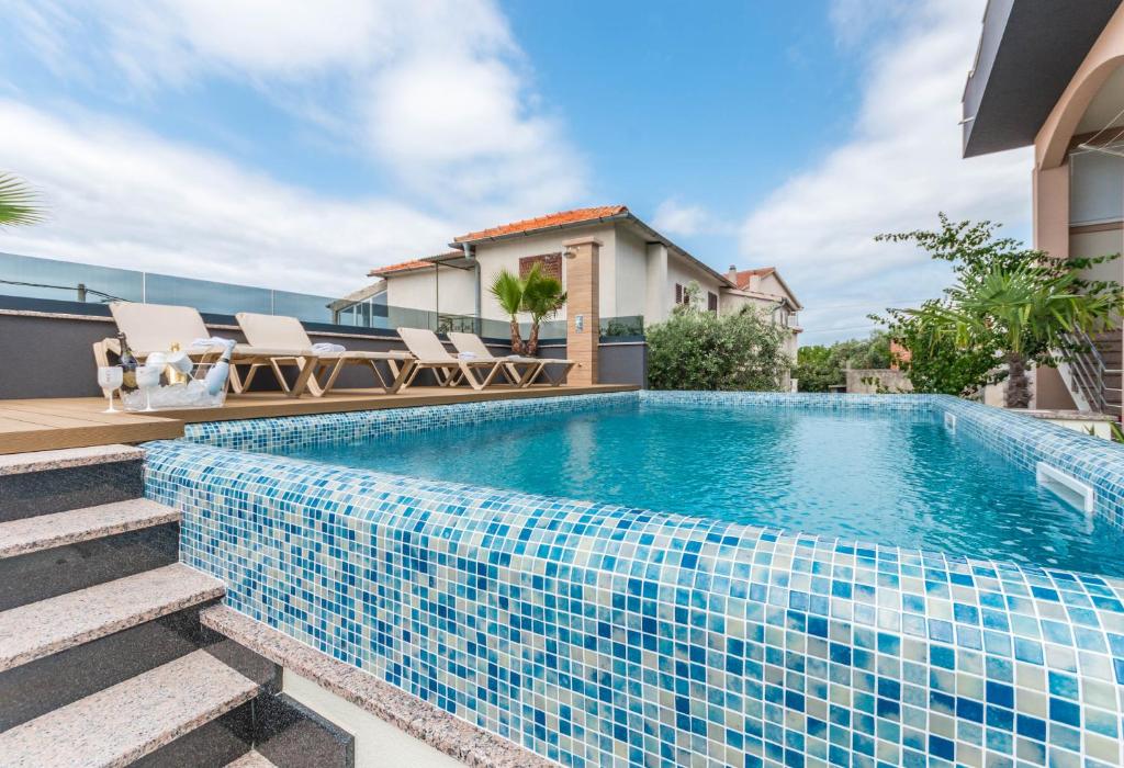 a swimming pool in a villa with a house at Top View Biograd in Biograd na Moru