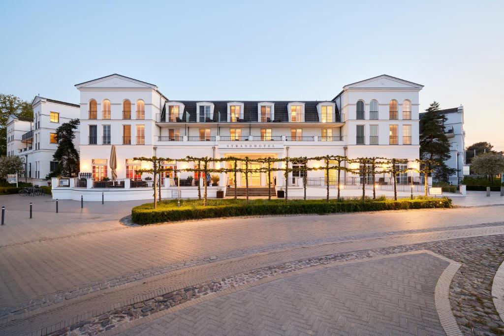a large building with lights in front of it at Strandhotel Zingst in Zingst