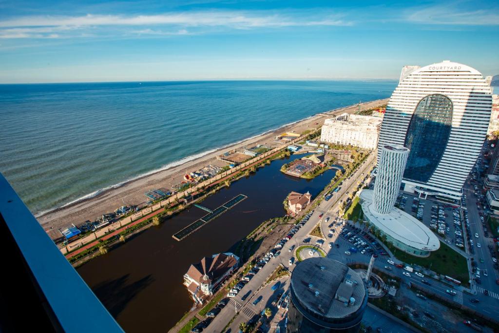 an aerial view of a city and the ocean at orbi city pearl hotel in Batumi