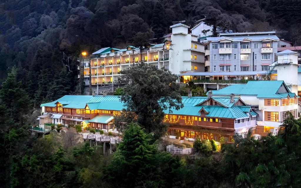 a hotel on the side of a mountain at night at Grand View Hotel in Dalhousie