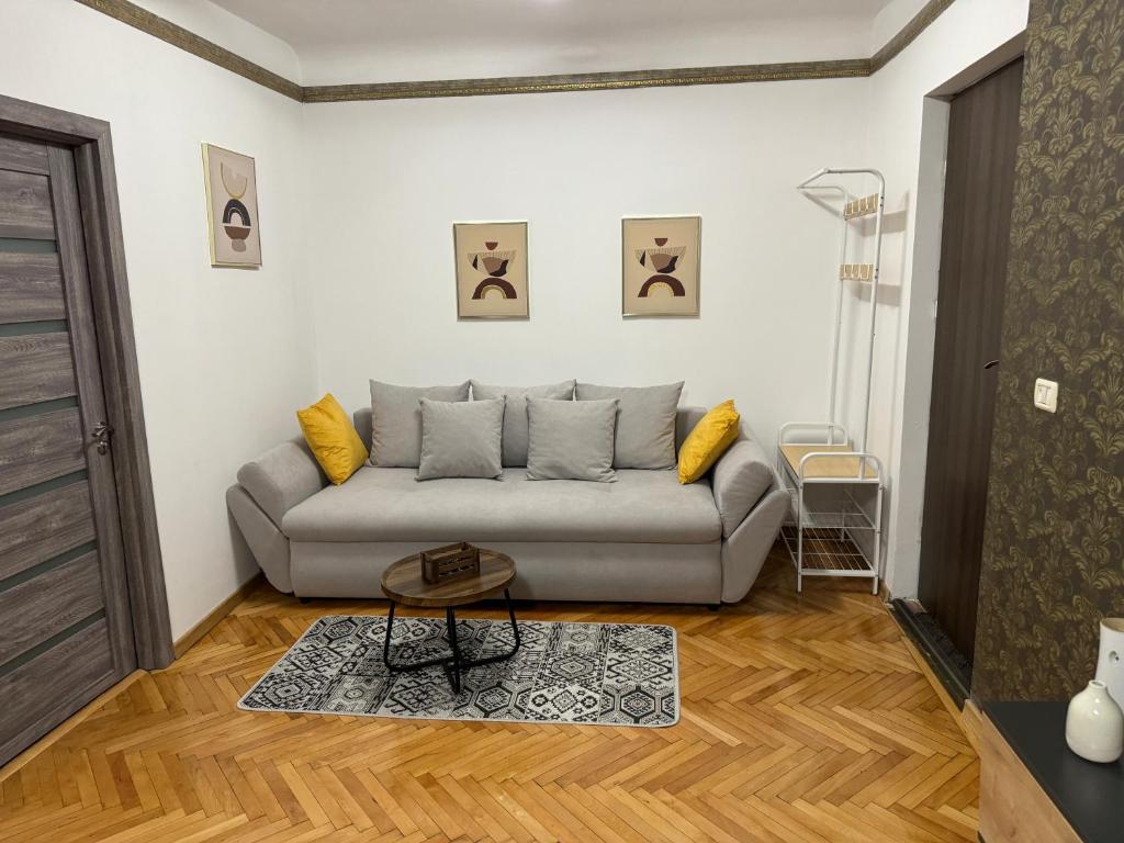 a living room with a couch and a table at Muresenilor Residence in Braşov