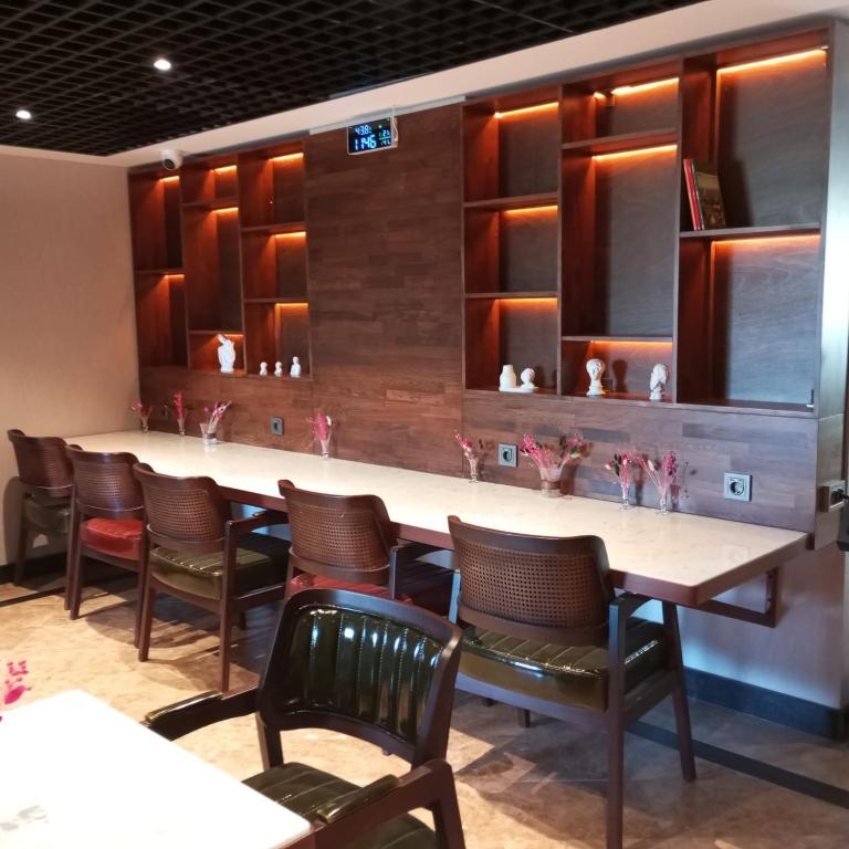 a bar with chairs and a long table in a restaurant at Cihangir Hotel Bosphorus in Istanbul