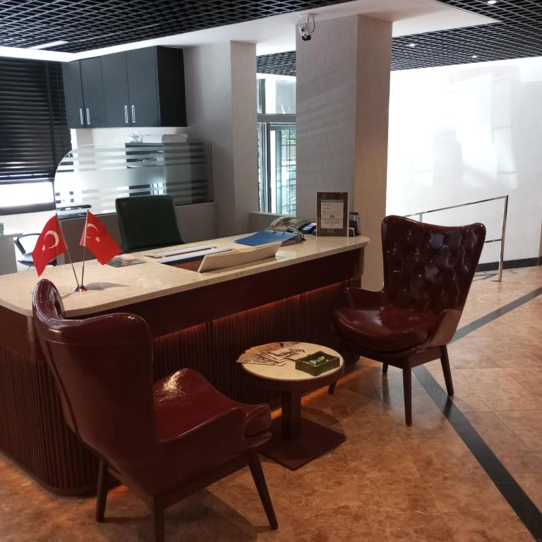 an office with a desk and two chairs and a table at Cihangir Hotel Bosphorus in Istanbul
