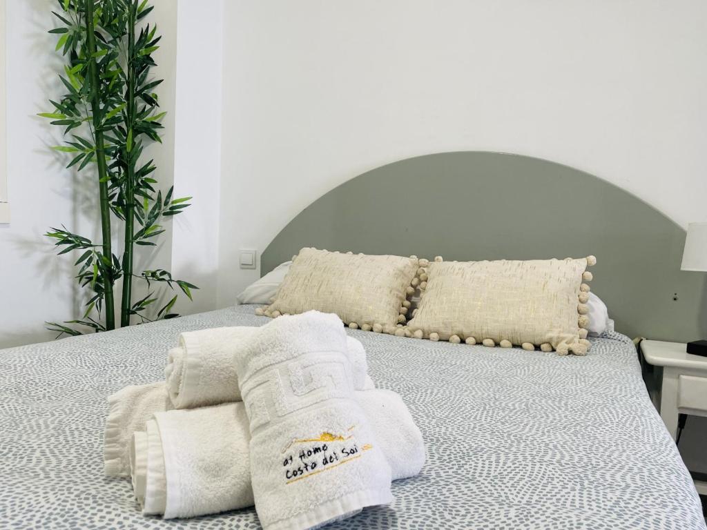 a bed with towels sitting on top of it at Estudio Jimena Carabeo en el centro de Nerja in Nerja