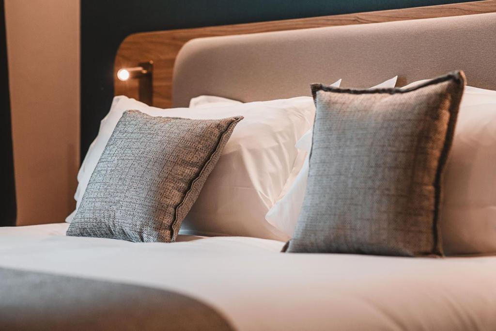 a white bed with two pillows on it at Holiday Inn Express Ajaccio by IHG in Ajaccio