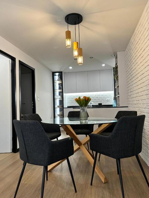 a dining room with a black table and chairs at Pink House in Monção