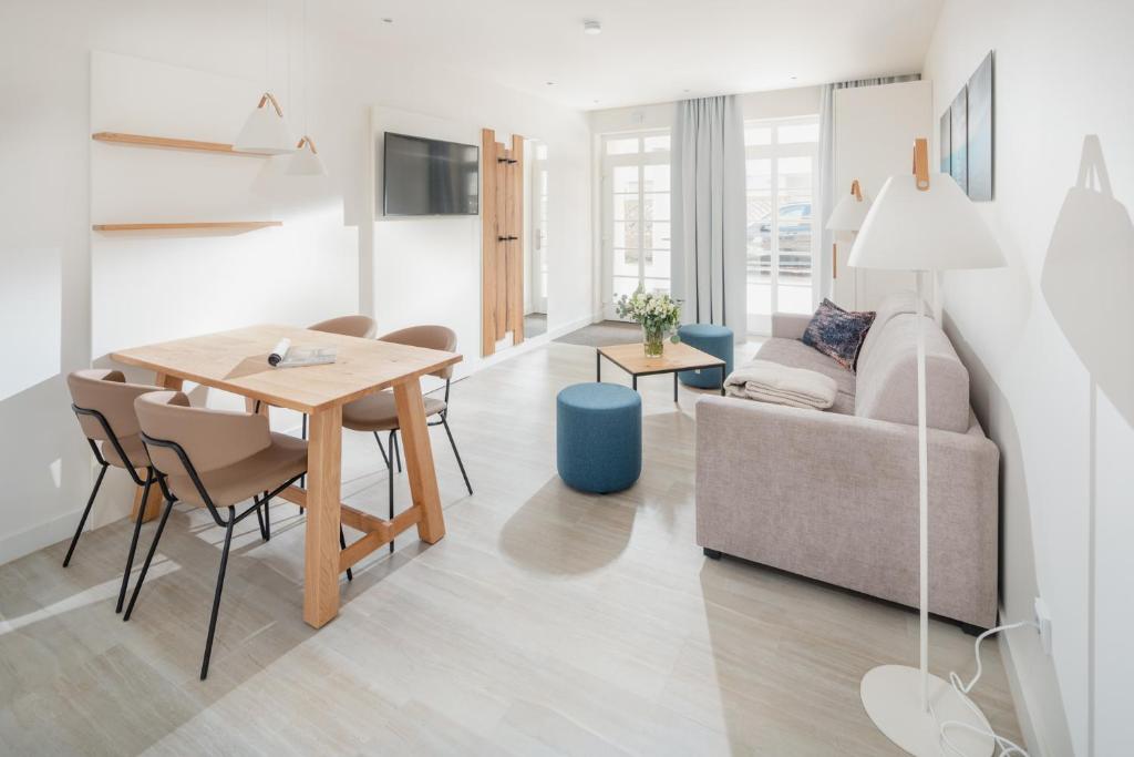a living room with a table and a couch at Nordstrandperle Ap S3 in Norderney