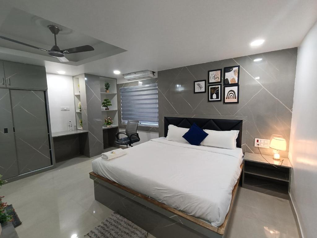 a bedroom with a large bed and a bathroom at Stayvilla in Rānchī