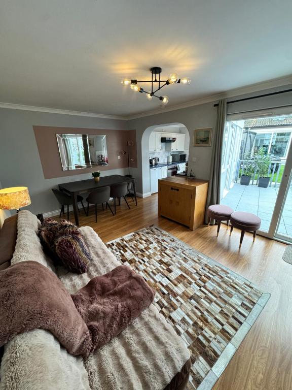 a living room with a couch and a dining room at Garden Place in Clevedon