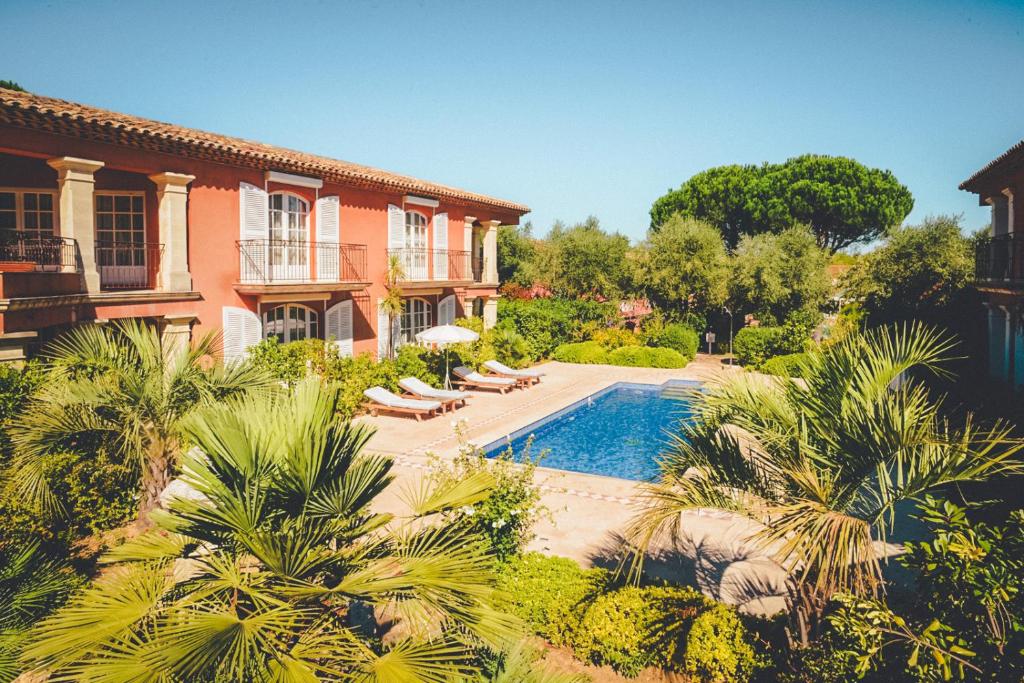 a swimming pool in front of a house at Domaine de l'Astragale in Saint-Tropez