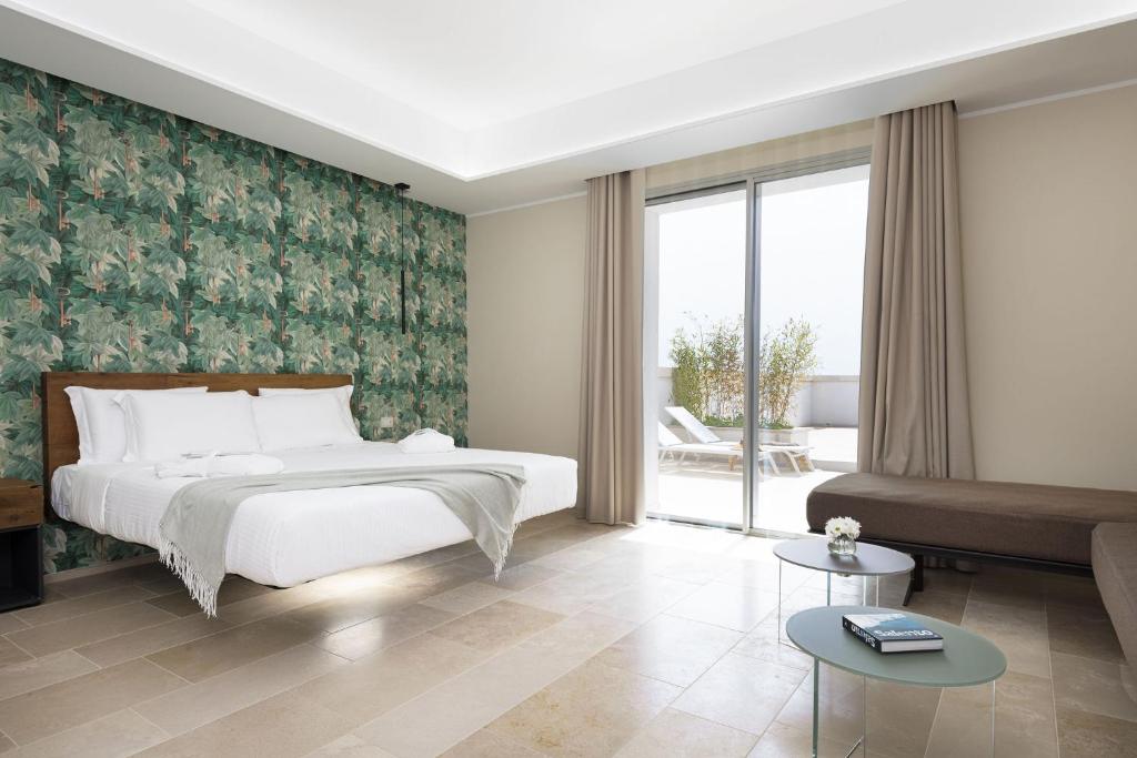 Postel nebo postele na pokoji v ubytování Torre Assunta Hotel