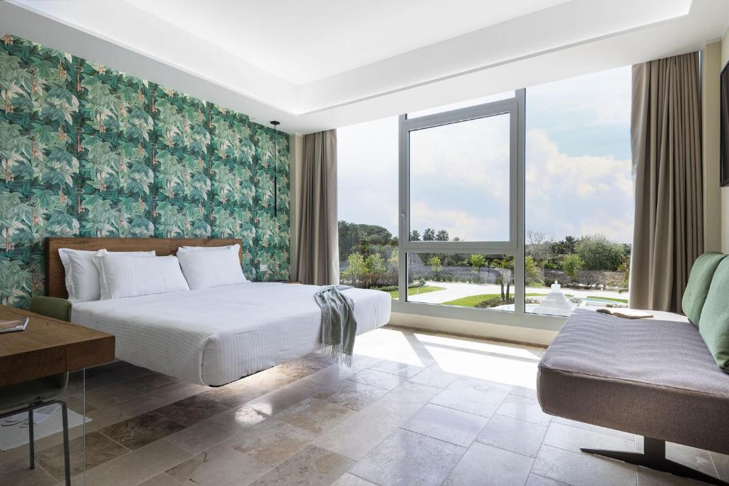 Postel nebo postele na pokoji v ubytování Torre Assunta Hotel