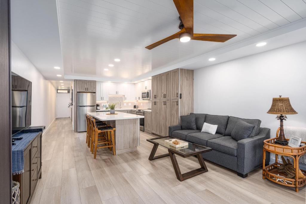 a living room with a couch and a kitchen at Kamaole Sands 1-305 in Wailea