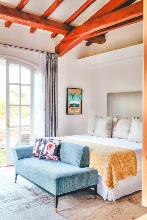 a bedroom with a large bed and a couch at Domaine de l'Astragale in Saint-Tropez