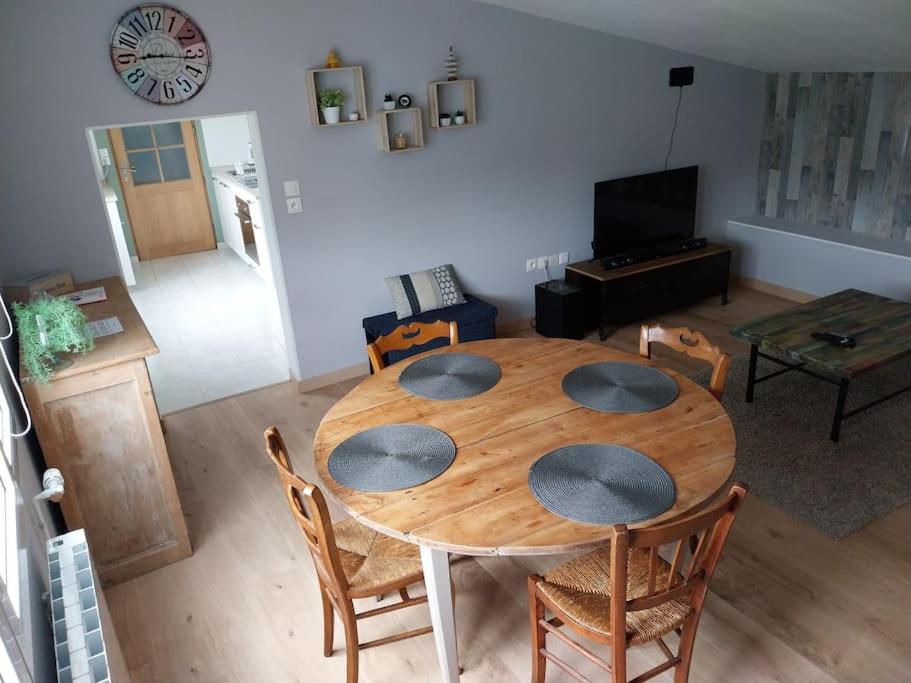 un salon avec une table et des chaises en bois dans l'établissement A mi-chemin entre Amiens et la Baie de Somme, à Forceville-en-Vimeu