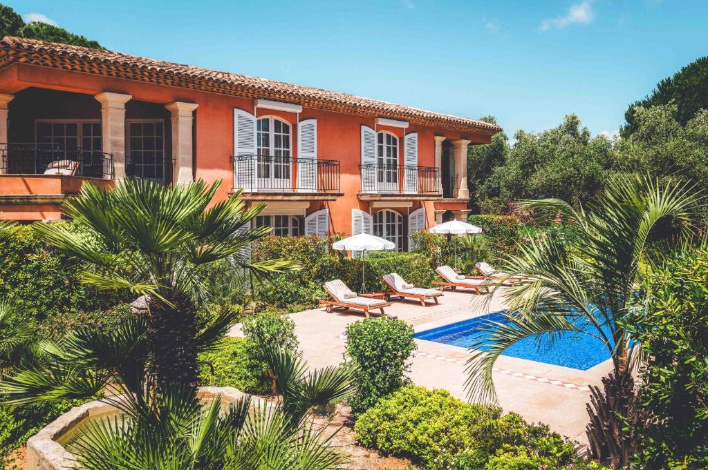a house with a swimming pool in front of it at Domaine de l'Astragale in Saint-Tropez