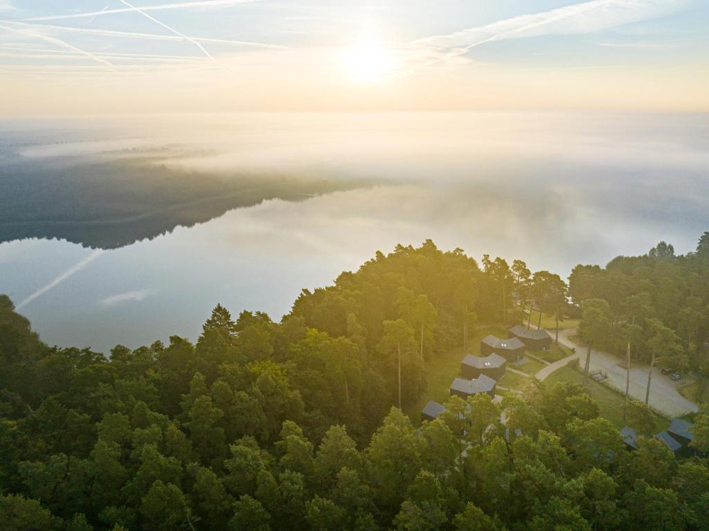 an aerial view of a misty lake and trees at Haus 1 - ELF AM SEE in Templin