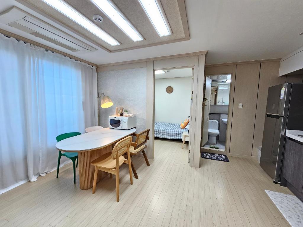 a kitchen and dining room with a table and chairs at My comfortable second house in Seoul