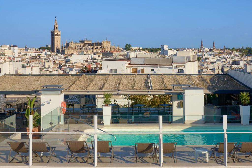 a view of a house with a swimming pool at Hotel Bécquer in Seville