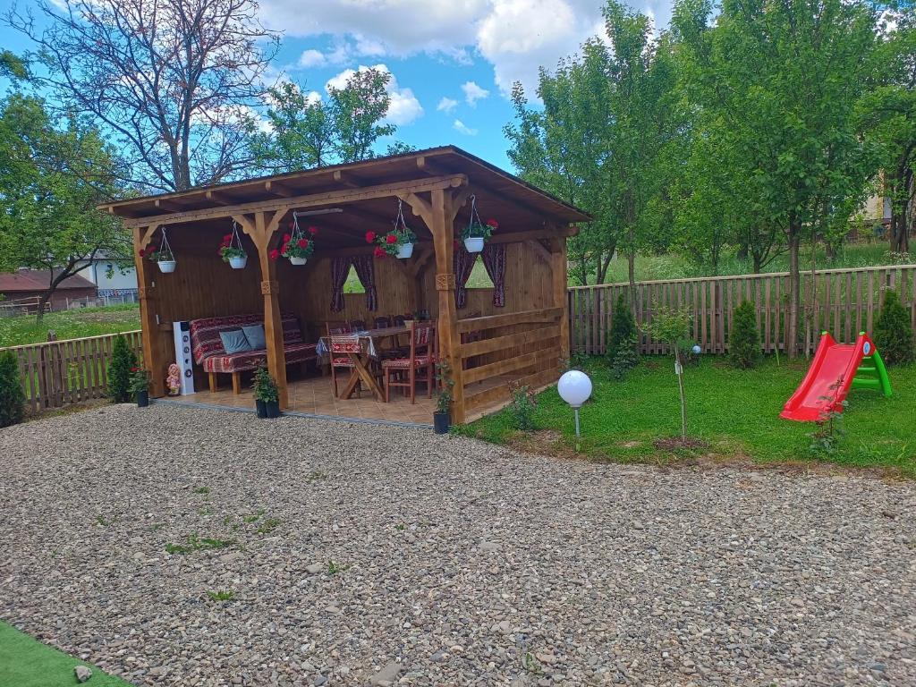a gazebo with a table and a playground at A frame Sima in Breb