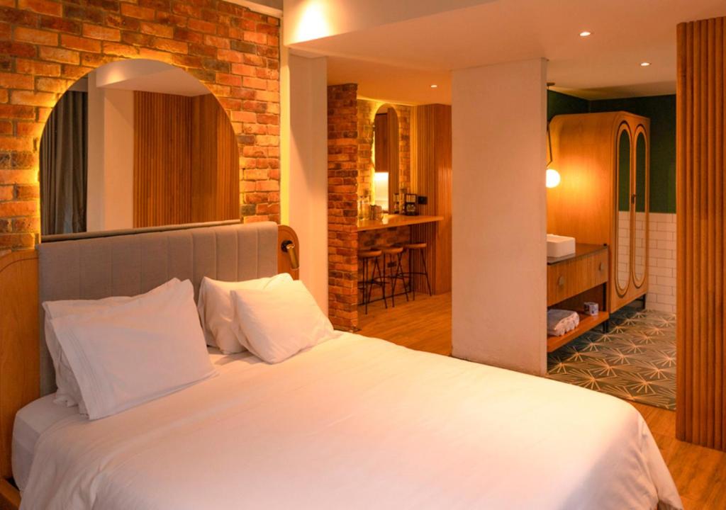 Postel nebo postele na pokoji v ubytování Nomada Hotel Origen