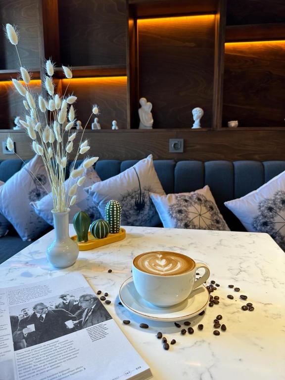 a cup of coffee sitting on top of a table at Cihangir Hotel Bosphorus in Istanbul