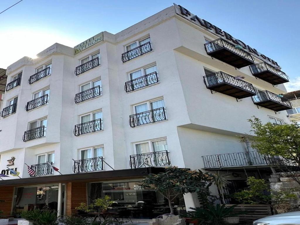 un gran edificio blanco con balcones. en Paperon Hotel, en Limonlu