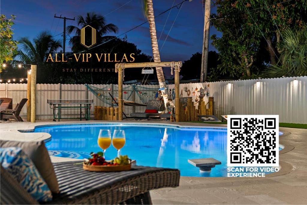 a swimming pool with two glasses of wine at Paradise Villa!!! Heated Pool, Games,10 min to Palm Beach & Airport in West Palm Beach