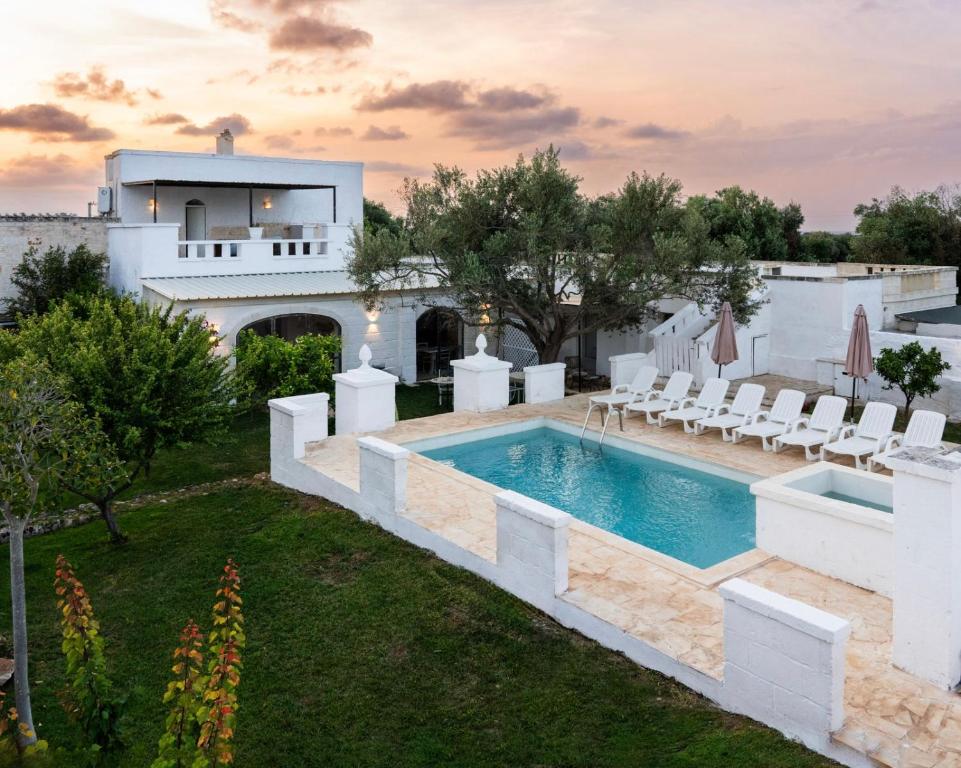 a pool in the backyard of a house at Masseria della Piana in Villanova di Ostuni