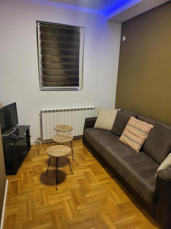 a living room with a couch and a table at E&M apartment in Zemun