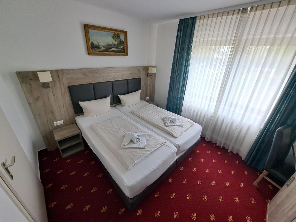 a bedroom with a bed with two napkins on it at Hotel Central Hauptbahnhof in Heidelberg