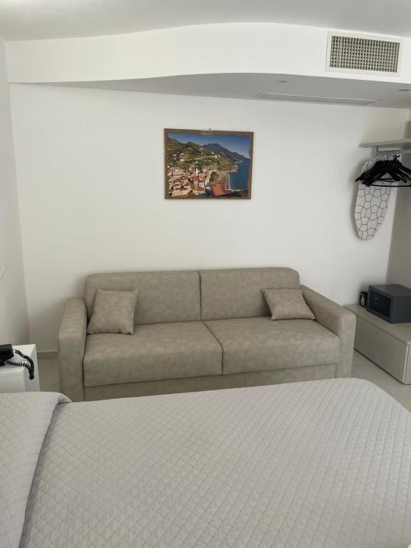 a living room with a couch and a bed at Amalfi Suite Boutique Hotel in Amalfi