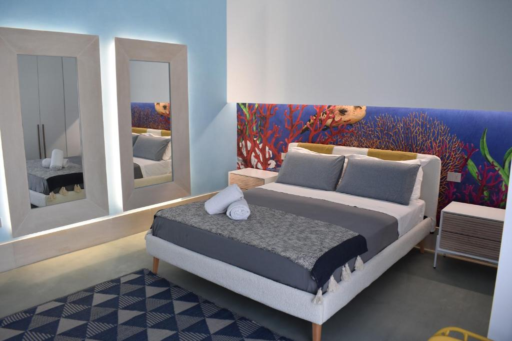 Giường trong phòng chung tại Bianco Mare Delfino Apartment