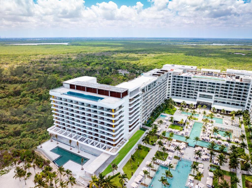 an aerial view of a resort building with a pool at Hotel Mousai Cancun Adults Only - All Inclusive in Cancún