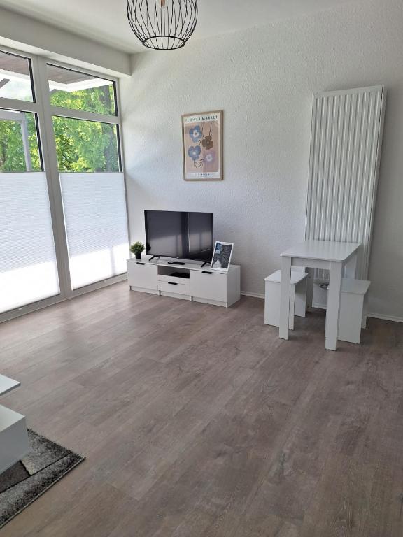 a living room with a television and a table at Ferienwohnung Werra in Bad Karlshafen