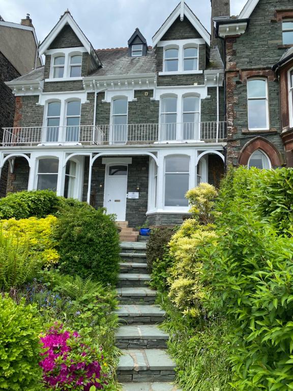 a large brick house with stairs in front of it at Berkeley House in Keswick