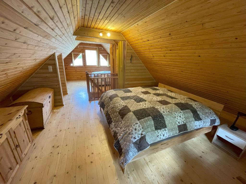 1 dormitorio con 1 cama en una cabaña de madera en Garten Eden, en Frohburg