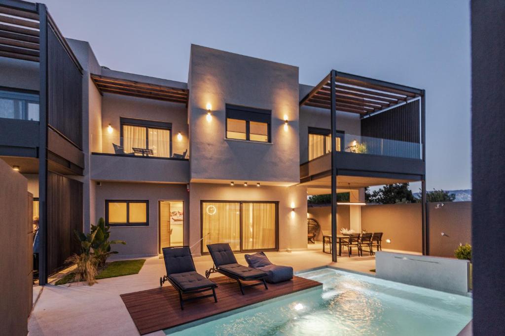 a house with a swimming pool in front of it at Kolchis Urban Villas in Volos