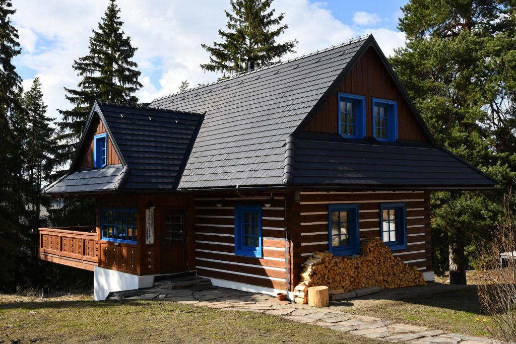 uma pequena casa com um telhado de gambrel em Tri borovice em Liptovský Mikuláš