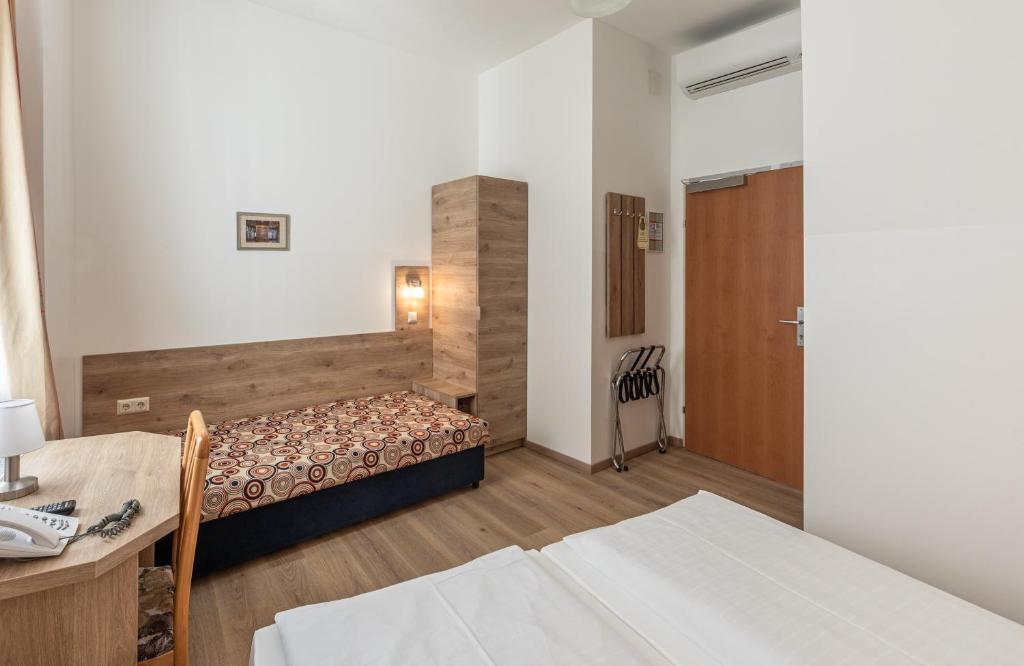 Postel nebo postele na pokoji v ubytování Hotel Terminus
